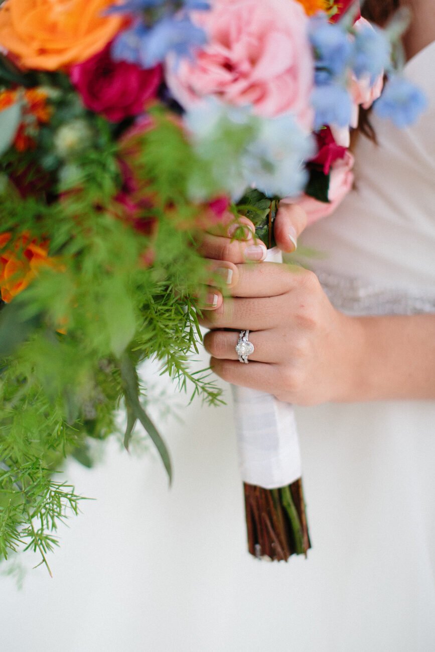 Colorful bridal bouquet with hints of greenery. #WeddingFlowers