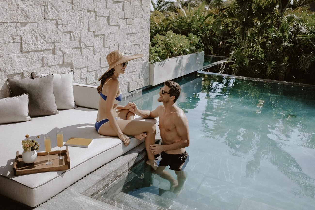 Couple relaxing in swimout pool at resort