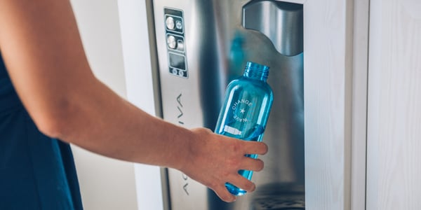 Person filling up water bottle